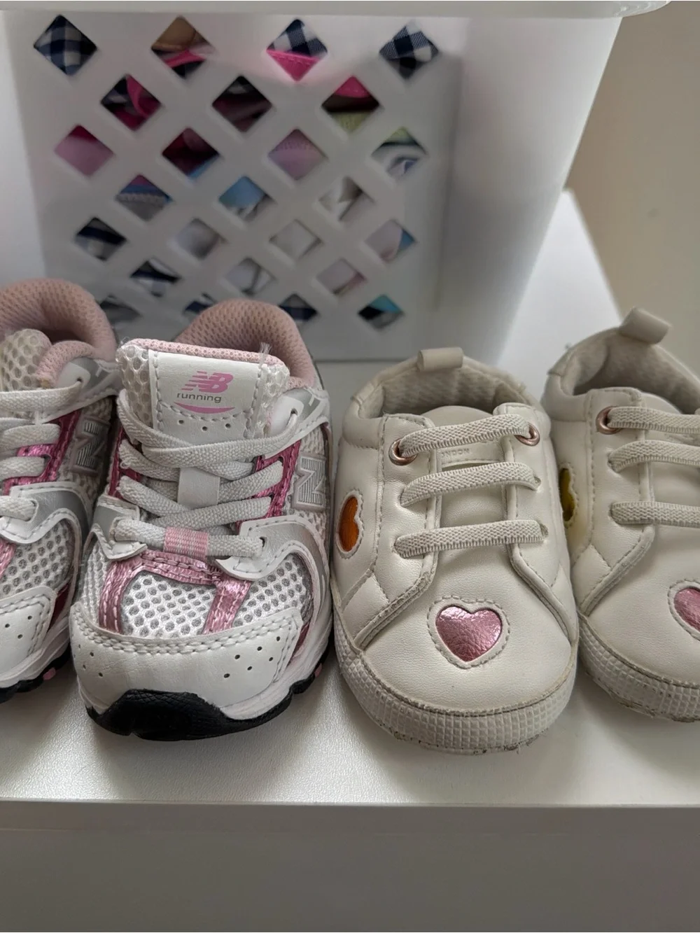 2 shoes . 1 New Balance White and Pink Kids Running Sneakers and 1 kurt geiger